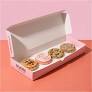 Open Crumbl cookie box with assorted cookies